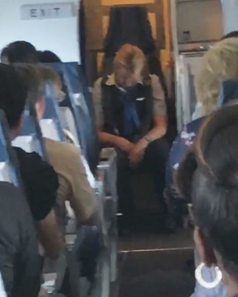 PHOTO: An image made from video shot on board a United Express flight from Chicago to East Bend, Ind., on Aug. 2, 2019, shows a flight attendant who was later charged with criminal public intoxication.