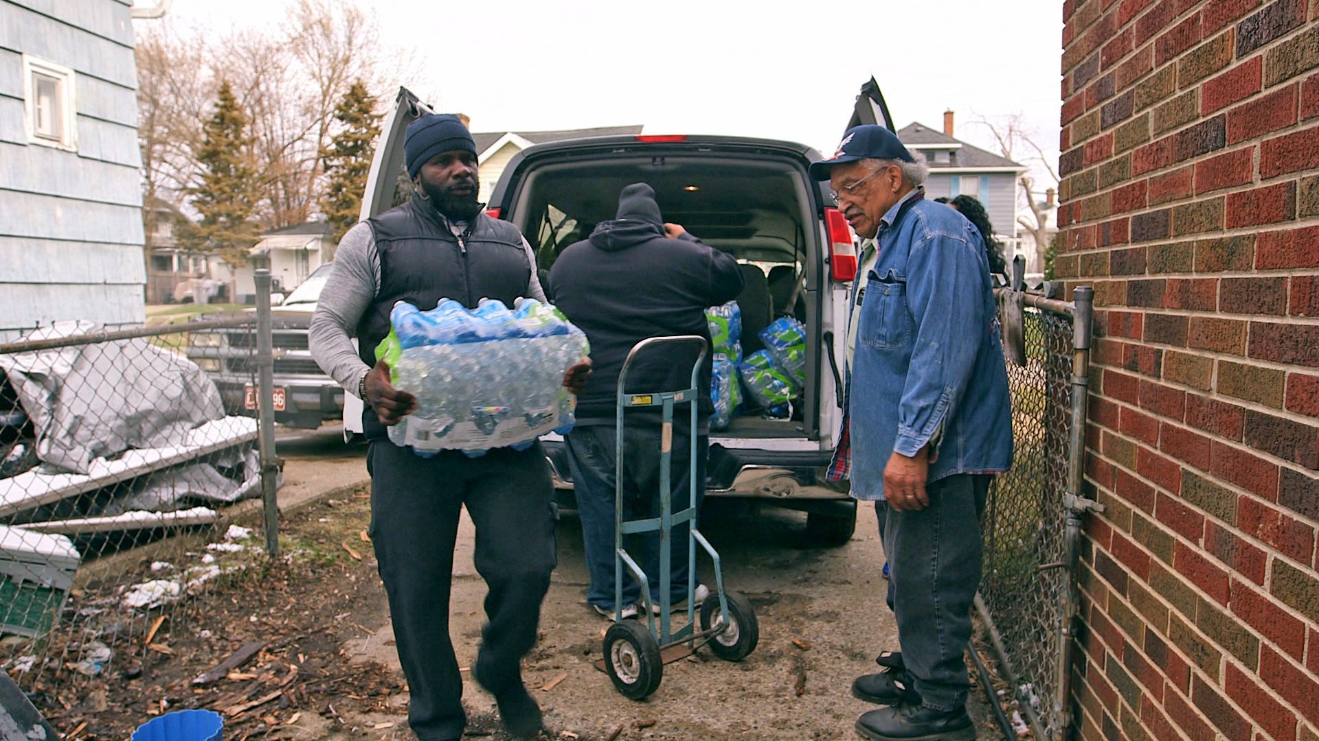 PHOTO: Pastor Jeffrey Hawkins and volunteers from Prince of Peace Missionary Baptist Church deliver donated water to residents in Flint.