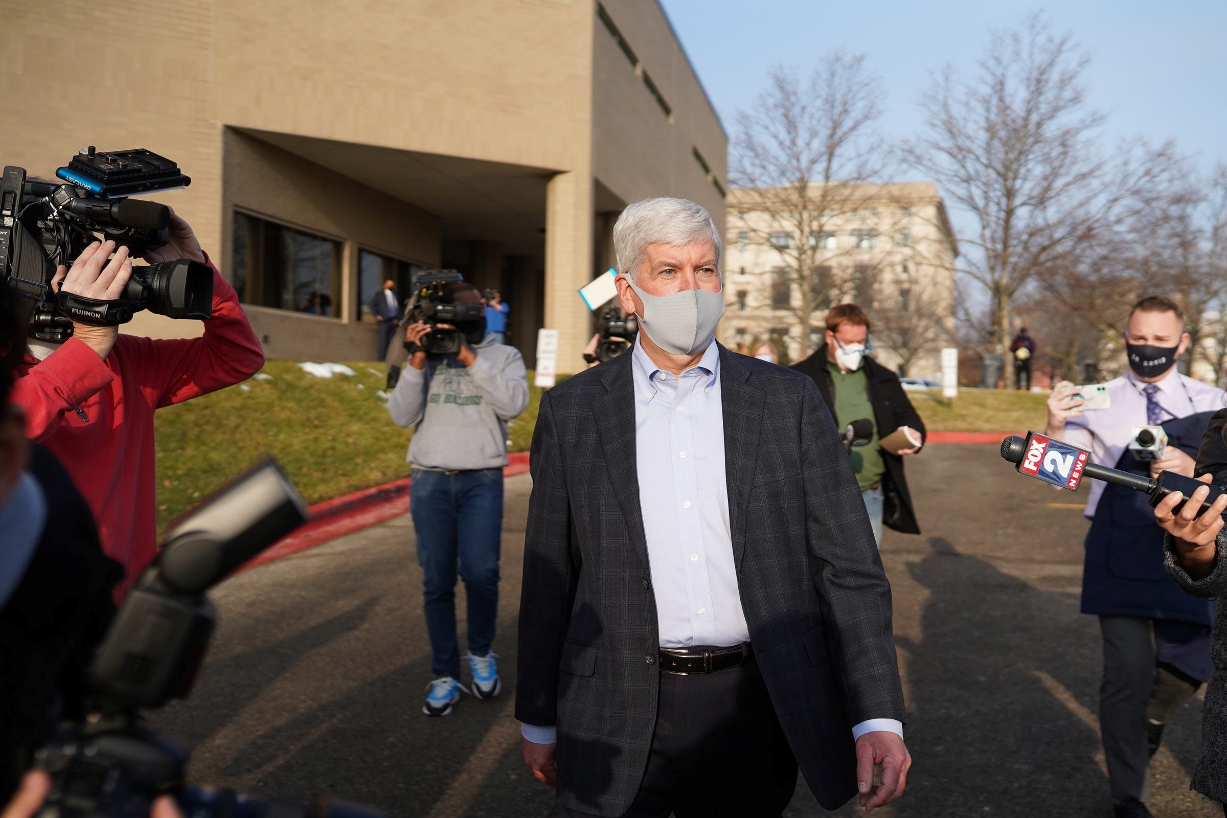 PHOTO: Former Michigan Governor Rick Snyder exits after video arraignment on two counts of willful neglect of duty over the lead-poisoning of drinking water in Flint, at the Genesee County Jail in Flint, Mich., Jan. 14, 2021.