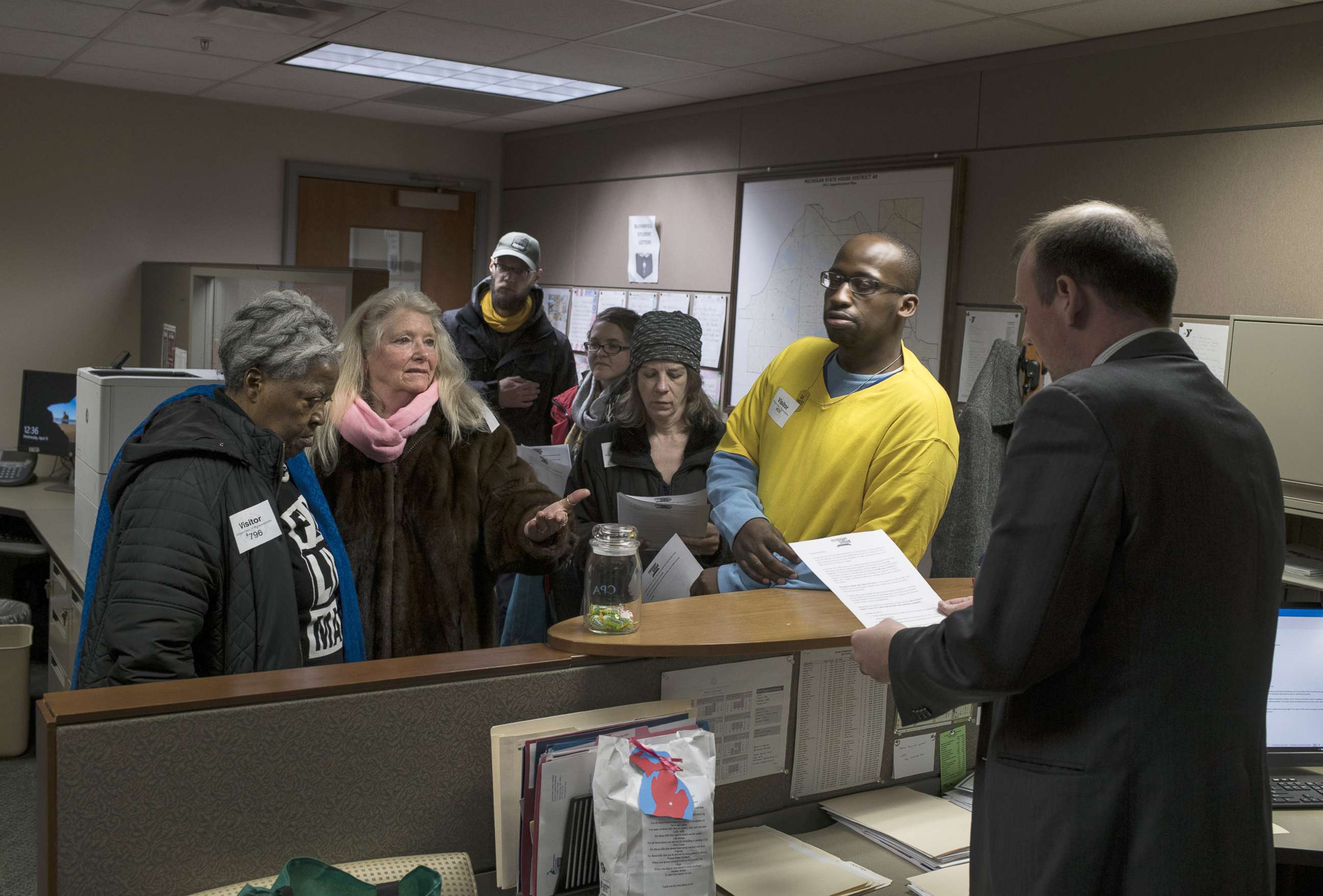 PHOTO: Alongside other protesters, Gladyes Williamson, of Flint, Michigan, delivers a list of demands, including a demand to keep water distribution sites open, to the offices of state representatives on April 11, 2018 in Lansing, Michigan.