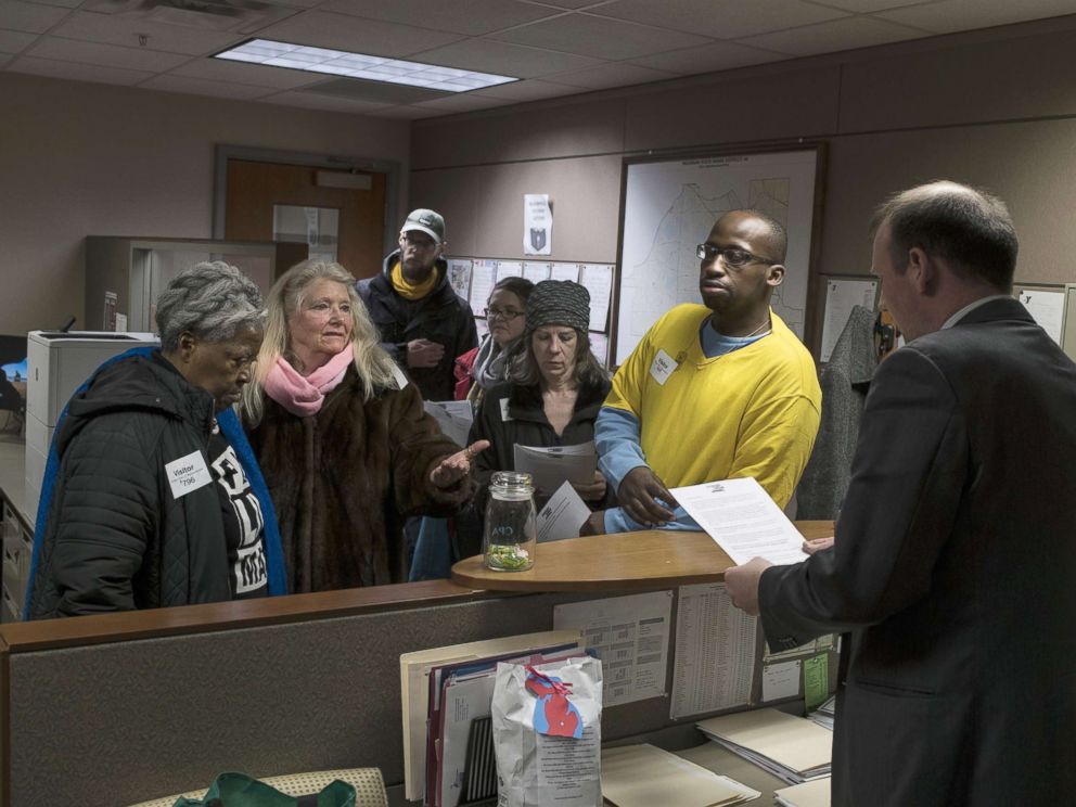 PHOTO: Alongside other protesters, Gladyes Williamson, of Flint, Michigan, delivers a list of demands, including a demand to keep water distribution sites open, to the offices of state representatives on April 11, 2018 in Lansing, Michigan.