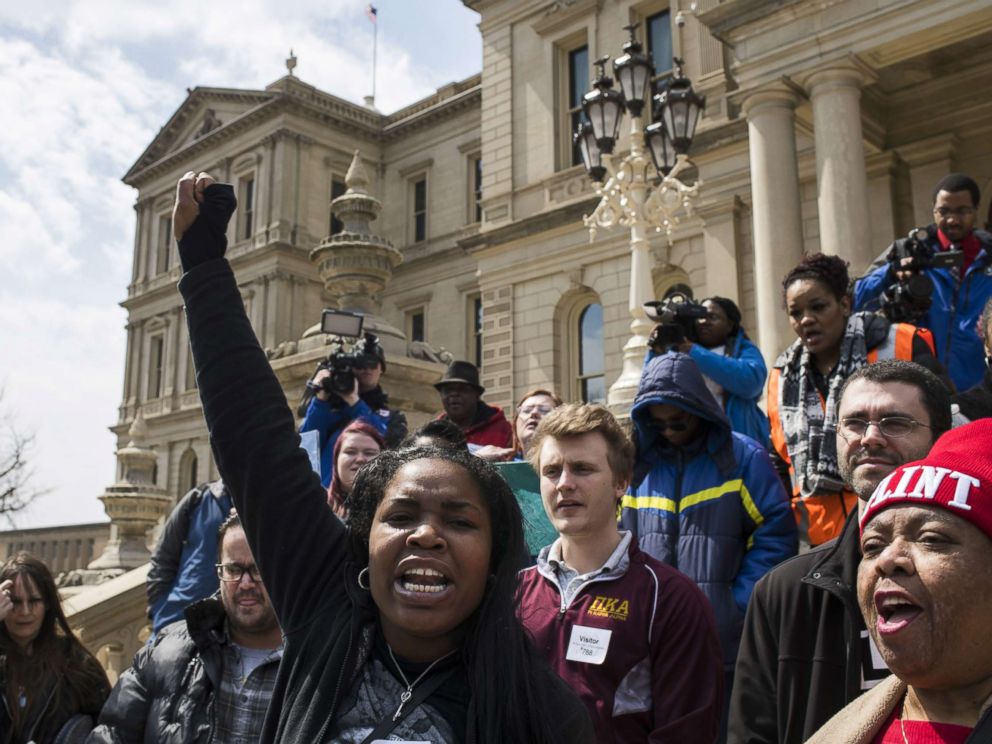 PHOTO: Ariana Hawk of Flint, Michigan, leads a chant during a protest on the steps of the Michigan State Capitol on April 11, 2018 in Lansing, Michigan.