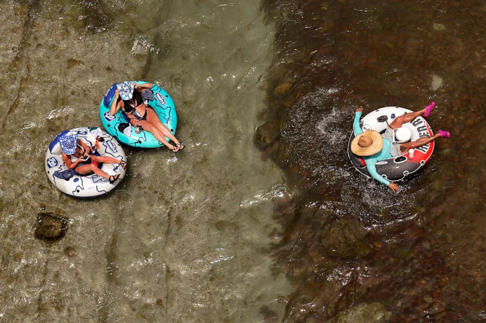 PHOTO: People float in the cool waters of the Comal River, June 14, 2022, in New Braunfels, Texas.