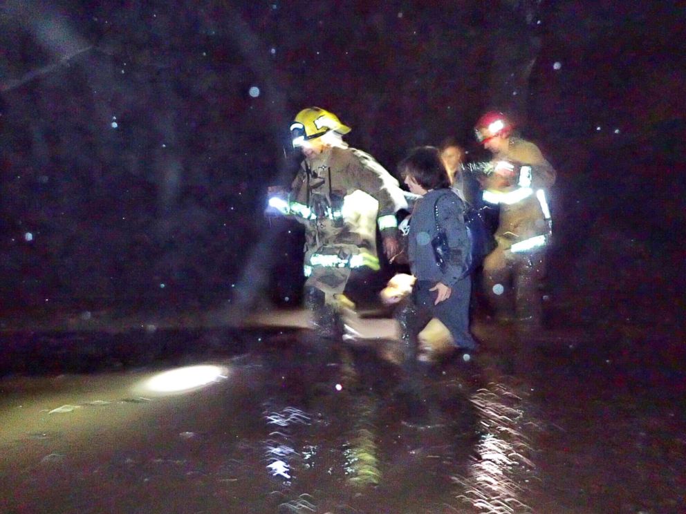 PHOTO: Emergency personnel rescue people from flood waters and debris after a mudslide in Montecito, Calif., in this photo provided by the Santa Barbara County Fire Department, Jan. 9, 2018. 