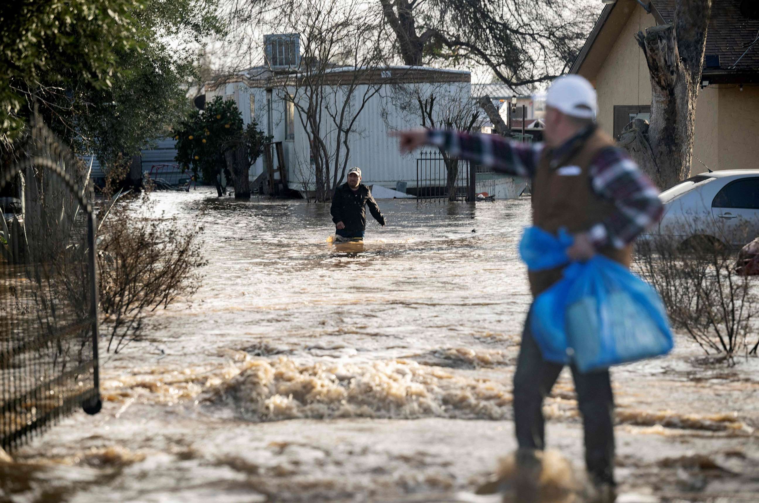 PHOTO: Residents scramble to retrieve belongings before flood waters rise too high Merced, California, on Jan. 10, 2023.