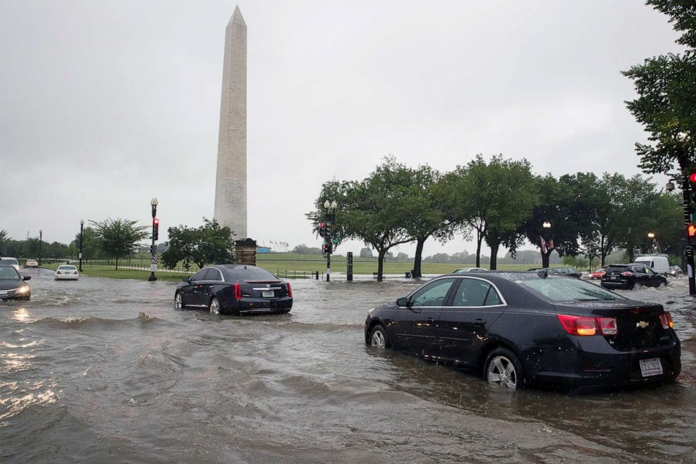 PHOTO: Heavy rainfall flooded the intersection of 15th Street and Constitution Ave., NW stalling cars in the street, on July 8, 2019, in Washington near the Washington Monument.