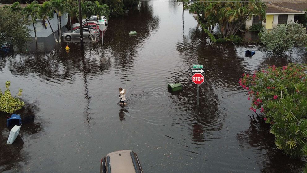 PHOTO: An aerial view from a drone shows a woman crossing a street inundated with flood water, Dec. 23, 2019, in Hallandale, Fla. 