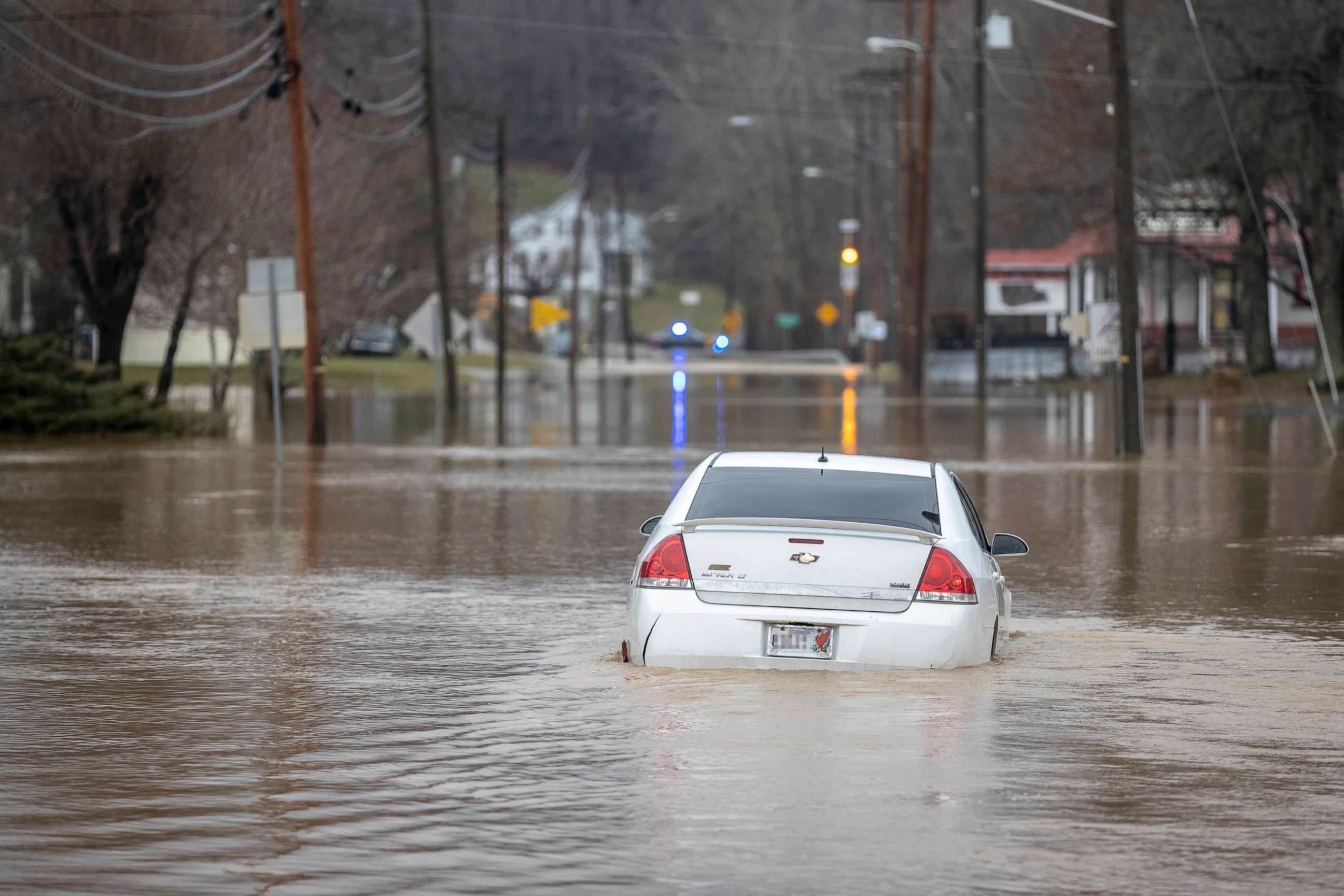 PHOTO: An abandoned car is surrounded by flood water on Kentucky Route 7 in Salyersville, Ky., March 1, 2021.