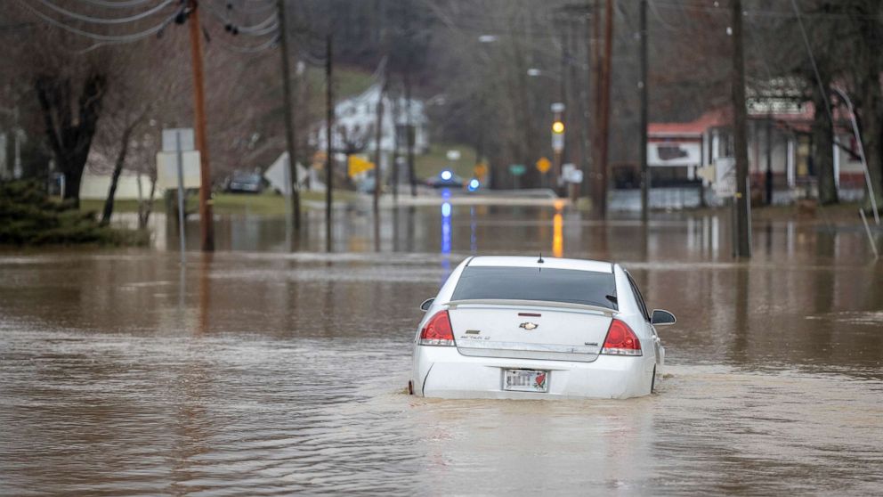 PHOTO: An abandoned car is surrounded by flood water on Kentucky Route 7 in Salyersville, Ky., March 1, 2021.