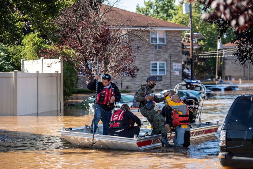 PHOTO: Stacie Holley steps off of a Wallington Emergency Squad boat after being rescued on Bel-Vista Court in Lodi, N.J., Sept. 2, 2021.