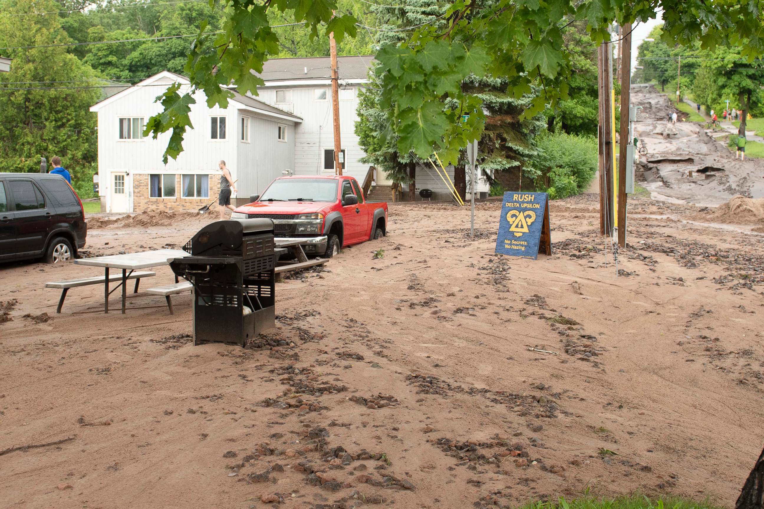 PHOTO: In this photo taken June 17, 2018, Agate Street is washed out wth dirt and debris covering the vehicles in Houghton, Mich.