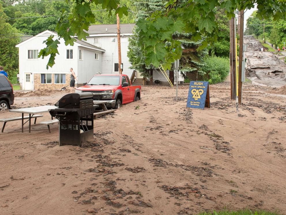 PHOTO: In this photo taken June 17, 2018, Agate Street is washed out wth dirt and debris covering the vehicles in Houghton, Mich.