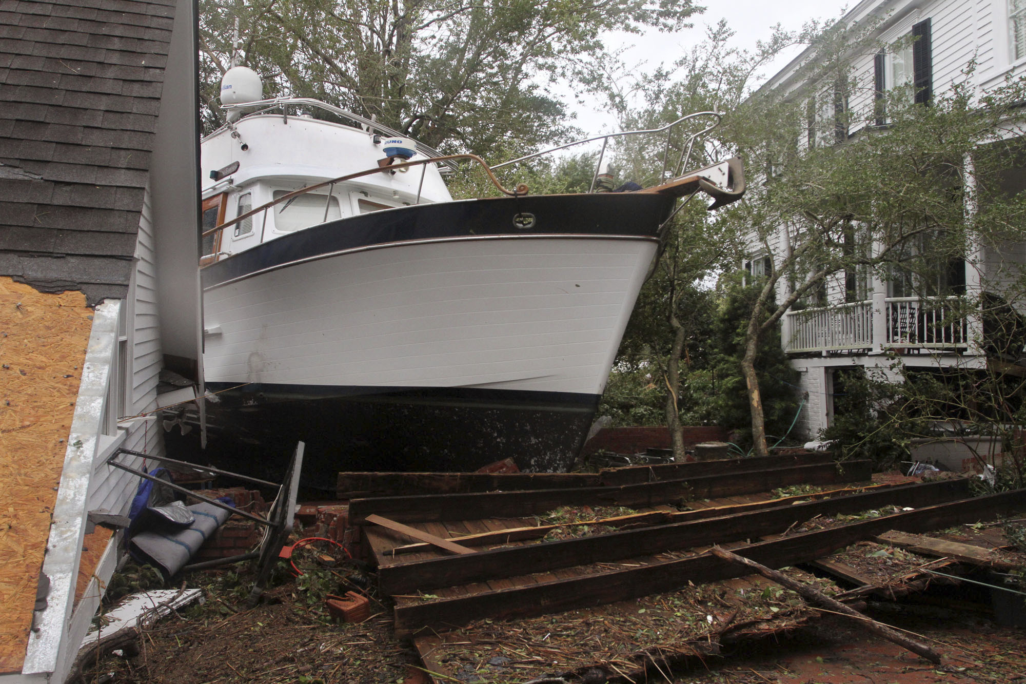 PHOTO: A 40-foot yacht lies in the yard of a storm-damaged home on East Front Street in New Bern, N.C., Saturday, Sept. 15, 2018. The boat washed up with storm surge and debris from Hurricane Florence.