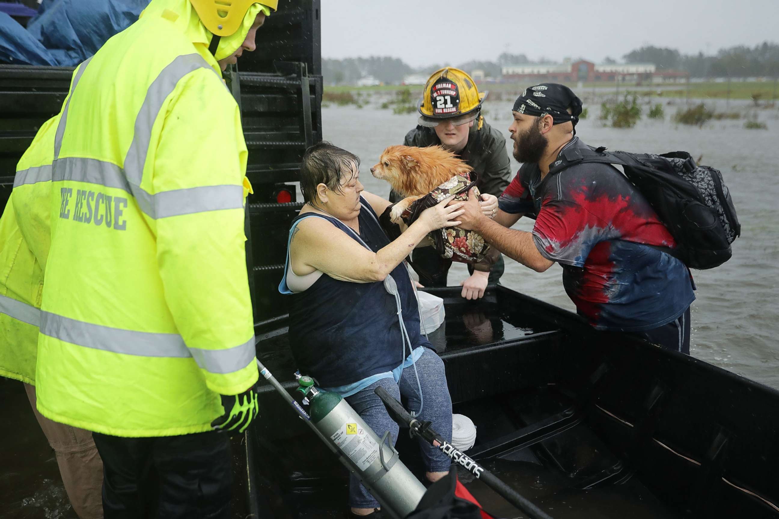 PHOTO: Rescue workers from Township No. 7 Fire Department and volunteers from the Civilian Crisis Response Team help rescue a woman and her dog from their flooded home during Hurricane Florence, Sept. 14, 2018, in James City, N.C.