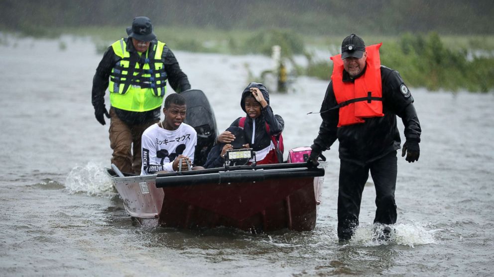 PHOTO: Volunteers from the Civilian Crisis Response Team help rescue three children from their flooded home, Sept. 14, 2018, in James City, N.C.