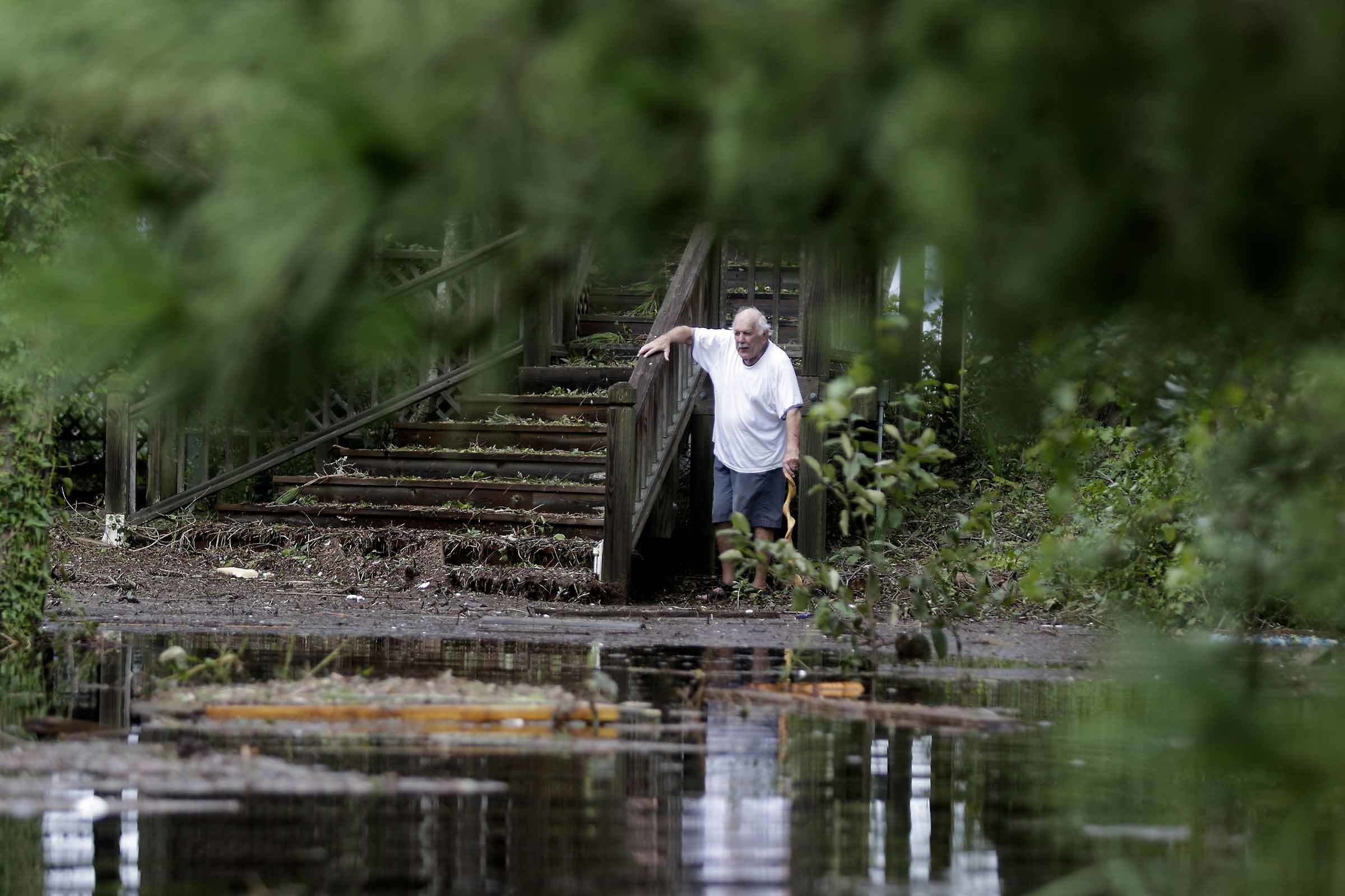 PHOTO: Elton Matheson, who rode out the storm, looks at the flooded waters in front of his home after Hurricane Florence hit Emerald Isle N.C.,Sunday, Sept. 16, 2018.