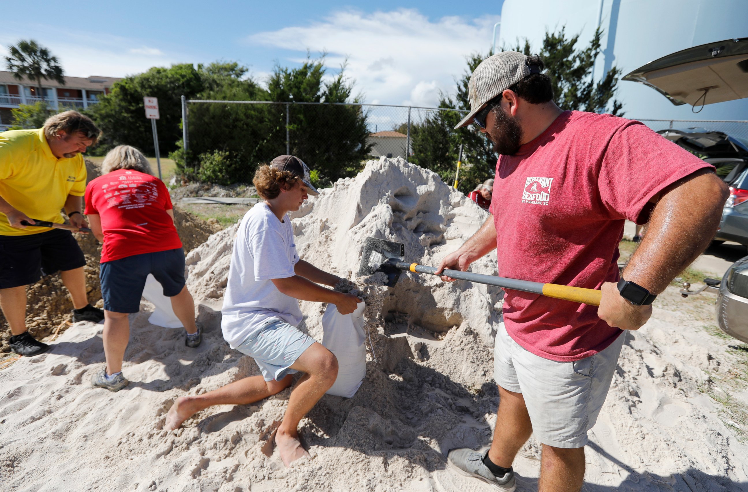 PHOTO: Walker Townsend, at right, from the Isle of Palms, S.C., fills a sand bag while Dalton Trout, in center, holds the bag at the Isle of Palms municipal lot in preparation for Hurricane Florence at the Isle of Palms S.C., Monday, Sept. 10, 2018.