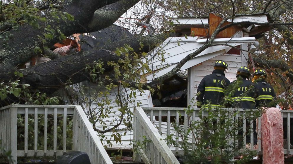 PHOTO: Firefighters arrive at a home where a large tree fell trapping people inside, after Hurricane Florence hit the area, Sept. 14, 2018 in Wilmington, N.C.