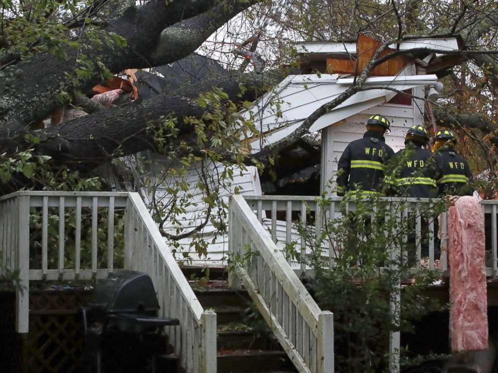 PHOTO: Firefighters arrive at a home where a large tree fell trapping people inside, after Hurricane Florence hit the area, Sept. 14, 2018 in Wilmington, N.C.