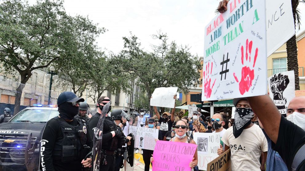 PHOTO: Police in riot gear look on during a protest against police brutality and racism, June 7, 2020 in Hollywood, Fla. The recent death of George Floyd while in police custody in Minneapolis ignited a global protest movement about racism and equality. 