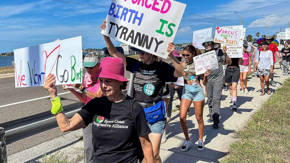PHOTO: Supporters of abortion rights march along the Eau Gallie Causeway, April 8, 2023, during the "Shove Your 6-Week Ban" rally, in Brevard, Fla.
