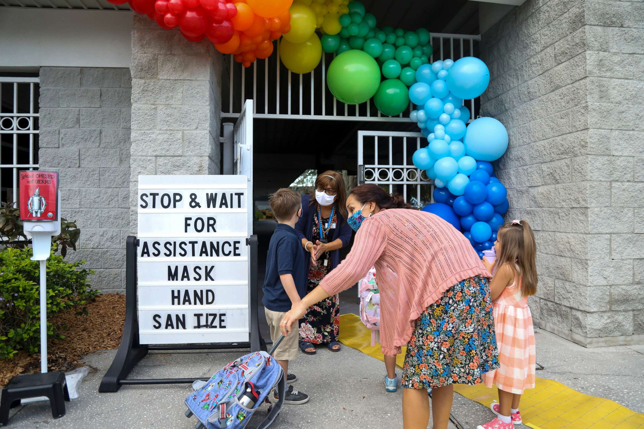 PHOTO: Hillel Academy staff help children arrive for the first day of the school year in Tampa, Florida, Aug. 12, 2020.