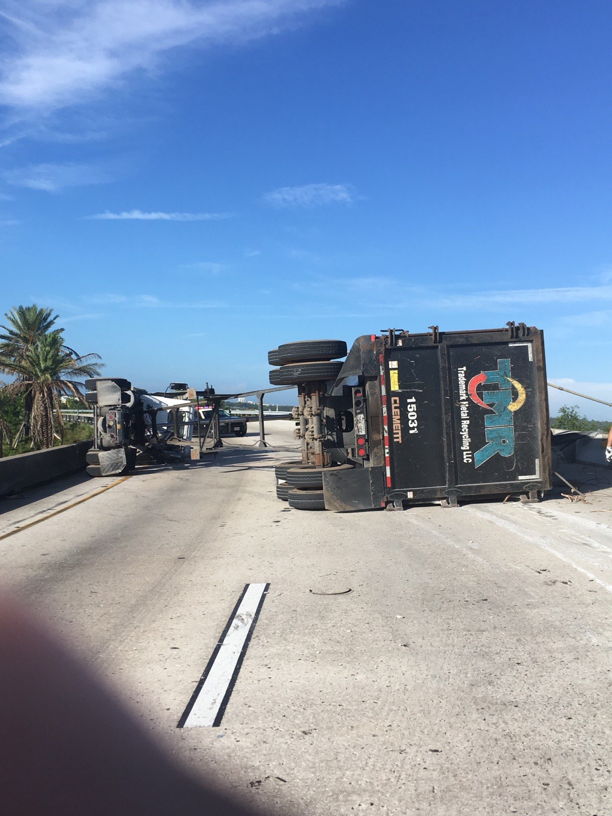 PHOTO: A man survived after a large piece of scrap metal fell from a truck that lost control and overturned on a highway, crushing his vehicle under the overpass, Orange County, Fla., July 15, 2017.