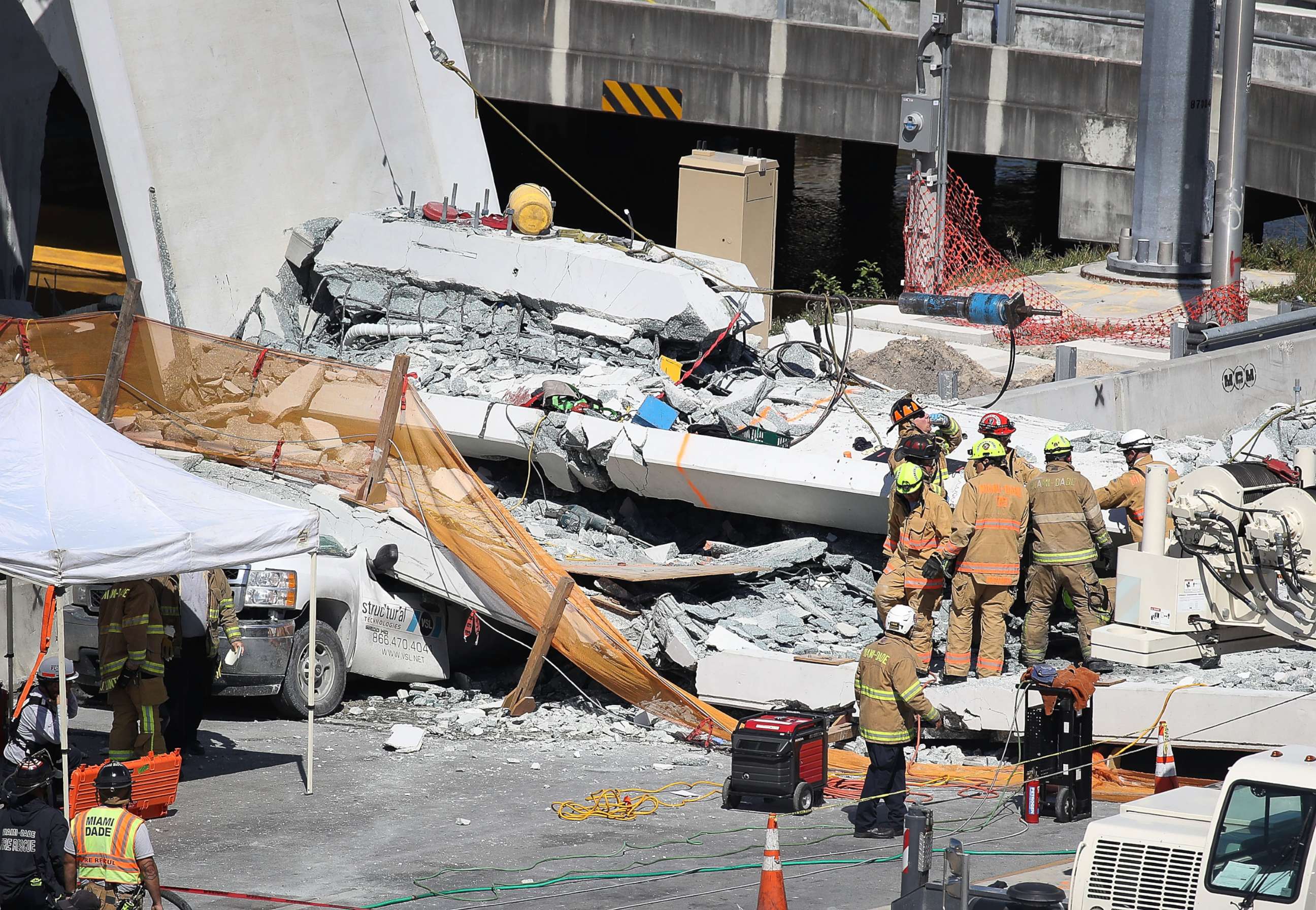 PHOTO: Miami-Dade Fire Rescue Department personnel and other rescue units work at the scene where a pedestrian bridge collapsed at Florida International University on March 15, 2018 in Miami.