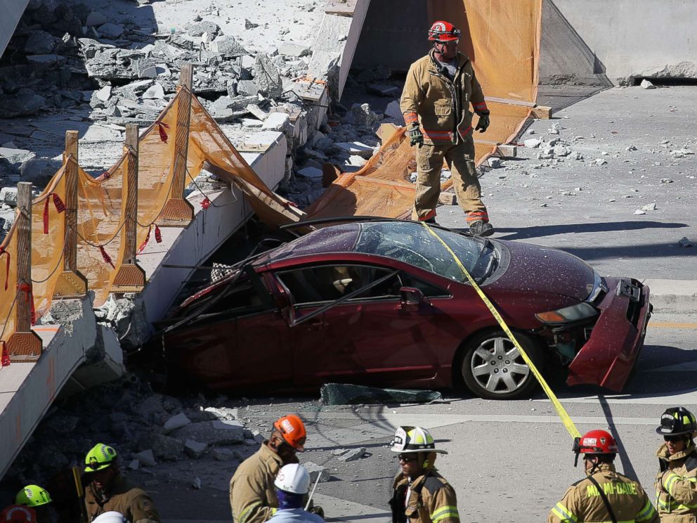 PHOTO: Miami-Dade Fire Rescue Department personnel and other rescue units work at the scene where a pedestrian bridge collapsed at Florida International University on March 15, 2018 in Miami.