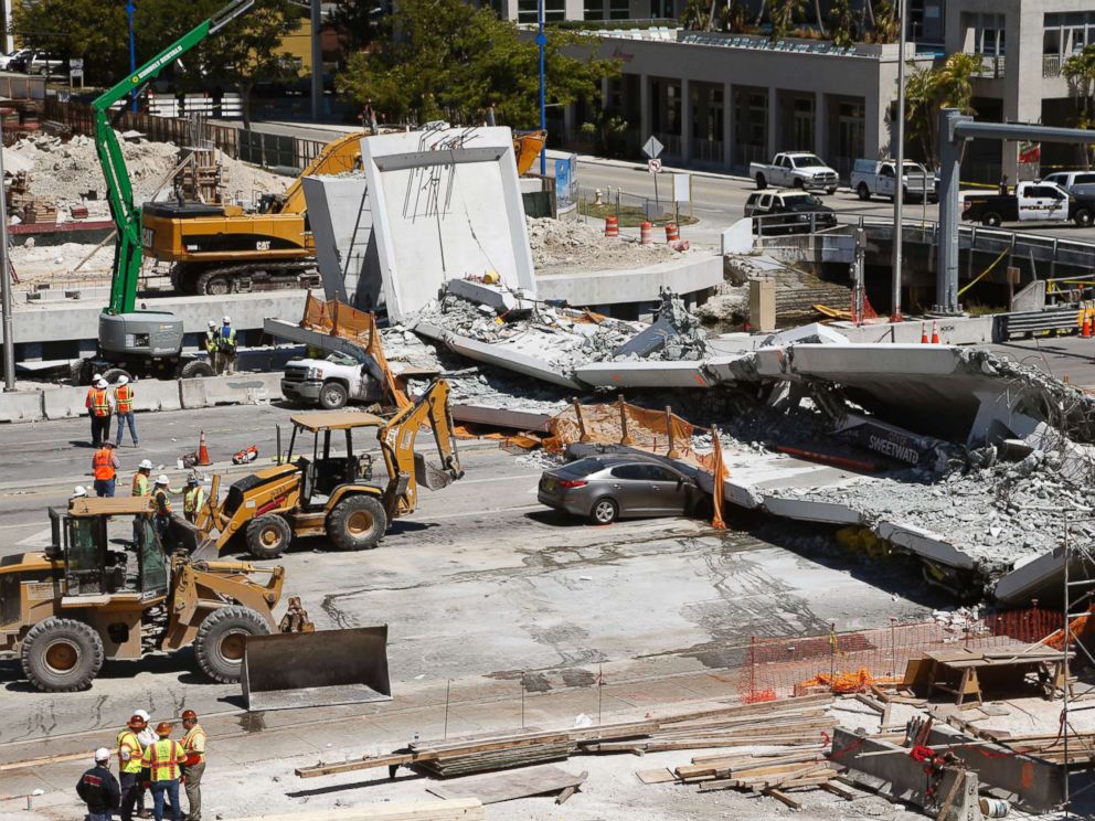 PHOTO: Crushed cars are shown under a section of a collapsed pedestrian bridge, March 16, 2018 near Florida International University in Miami.