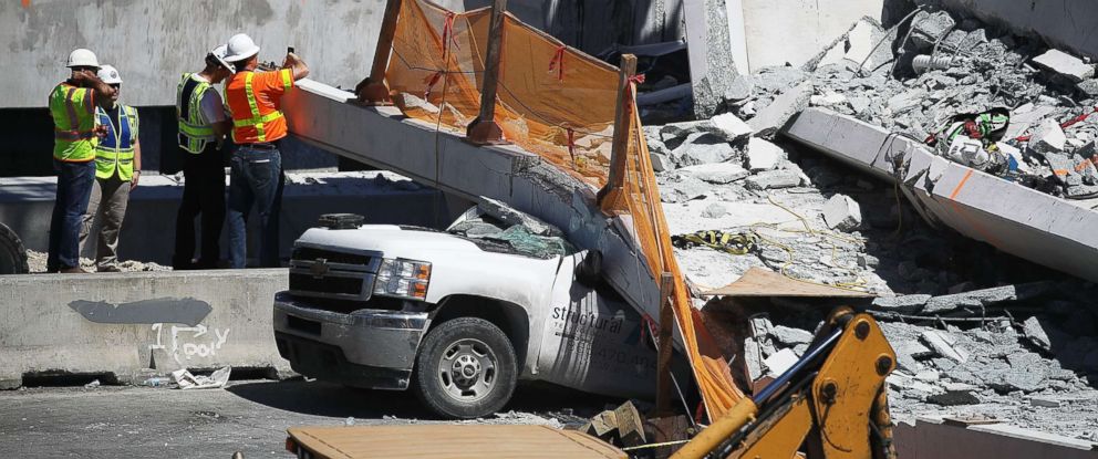 PHOTO: Members of the National Transportation Safety Board investigate the scene where a pedestrian bridge collapsed on March 15, near Florida International University in Miami, March 16, 2018.