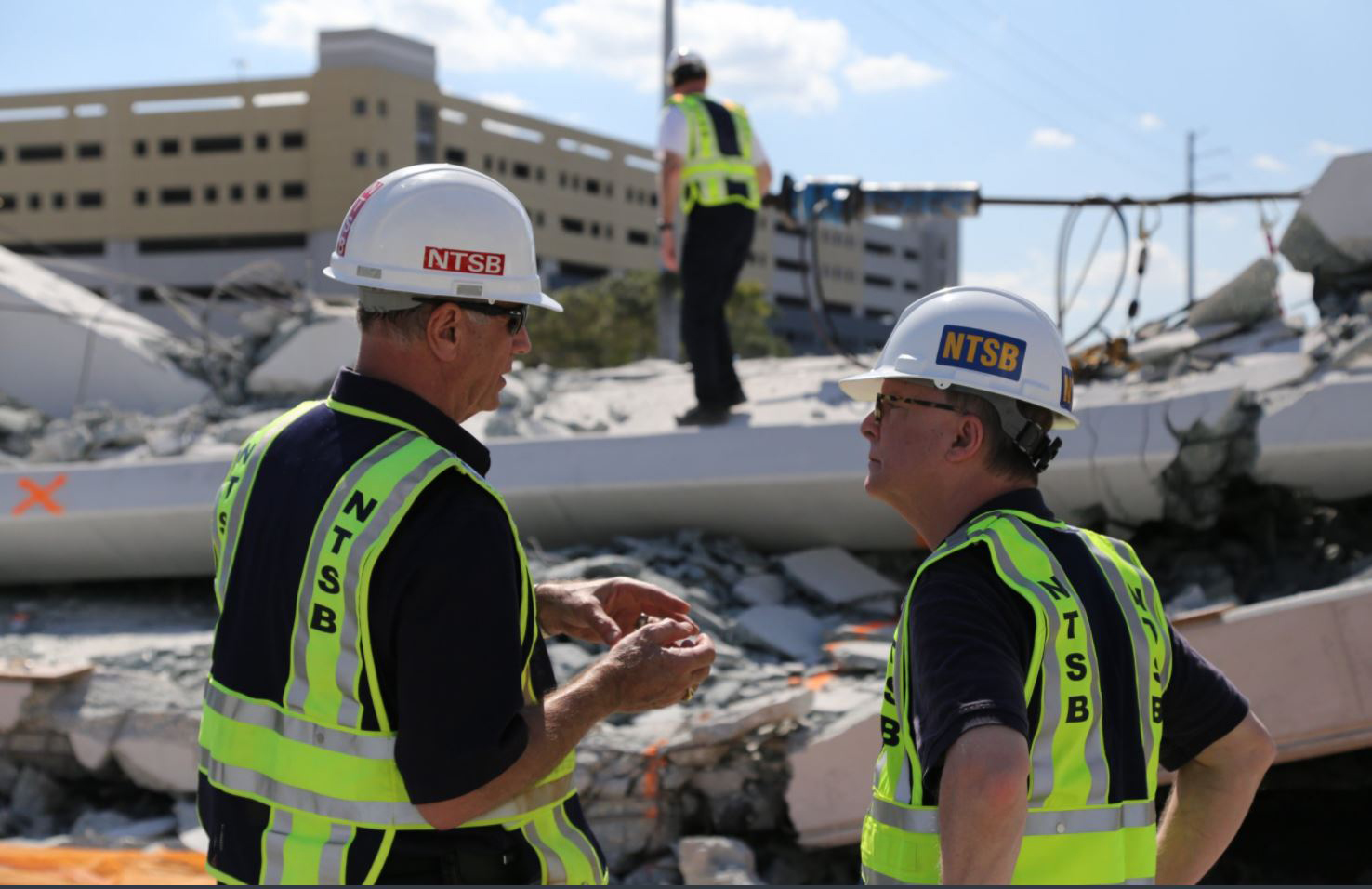 PHOTO: NTSB examine the debris from Thursday's collapse of a bridge on FIU's campus, March 16, 2018 in Miami.