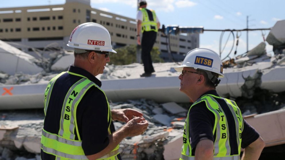 PHOTO: NTSB examine the debris from Thursday's collapse of a bridge on FIU's campus, March 16, 2018 in Miami.