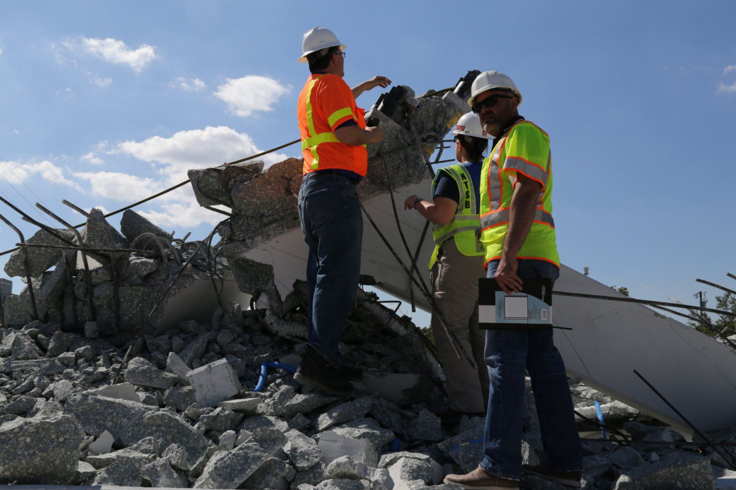 PHOTO: NTSB examine the debris from Thursday's collapse of a bridge on FIU's campus, March 16, 2018 in Miami.