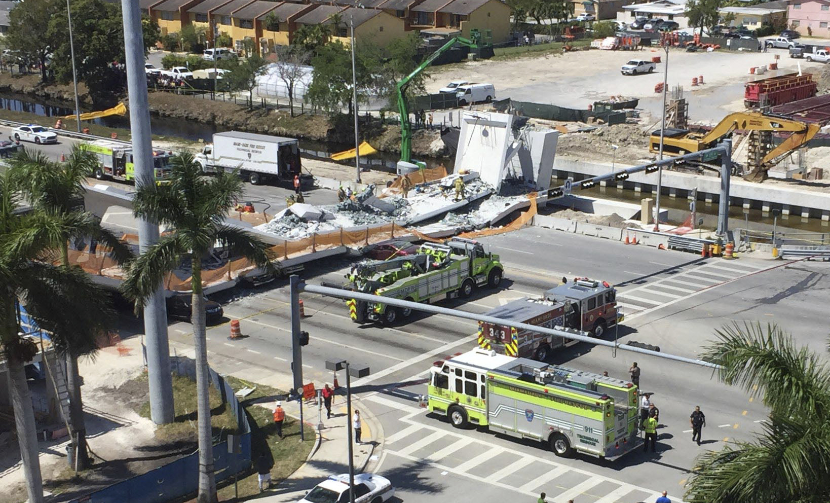 PHOTO: Emergency personnel responds to a collapsed pedestrian bridge connecting Florida International University on March 15, 2018 in the Miami area. The  brand-new pedestrian bridge collapsed onto a highway crushing at least five vehicles.