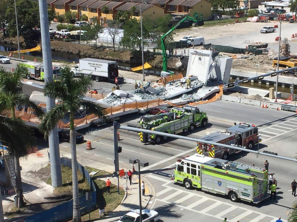 PHOTO: Emergency personnel responds to a collapsed pedestrian bridge connecting Florida International University on March 15, 2018 in the Miami area. The brand-new pedestrian bridge collapsed onto a highway crushing at least five vehicles.