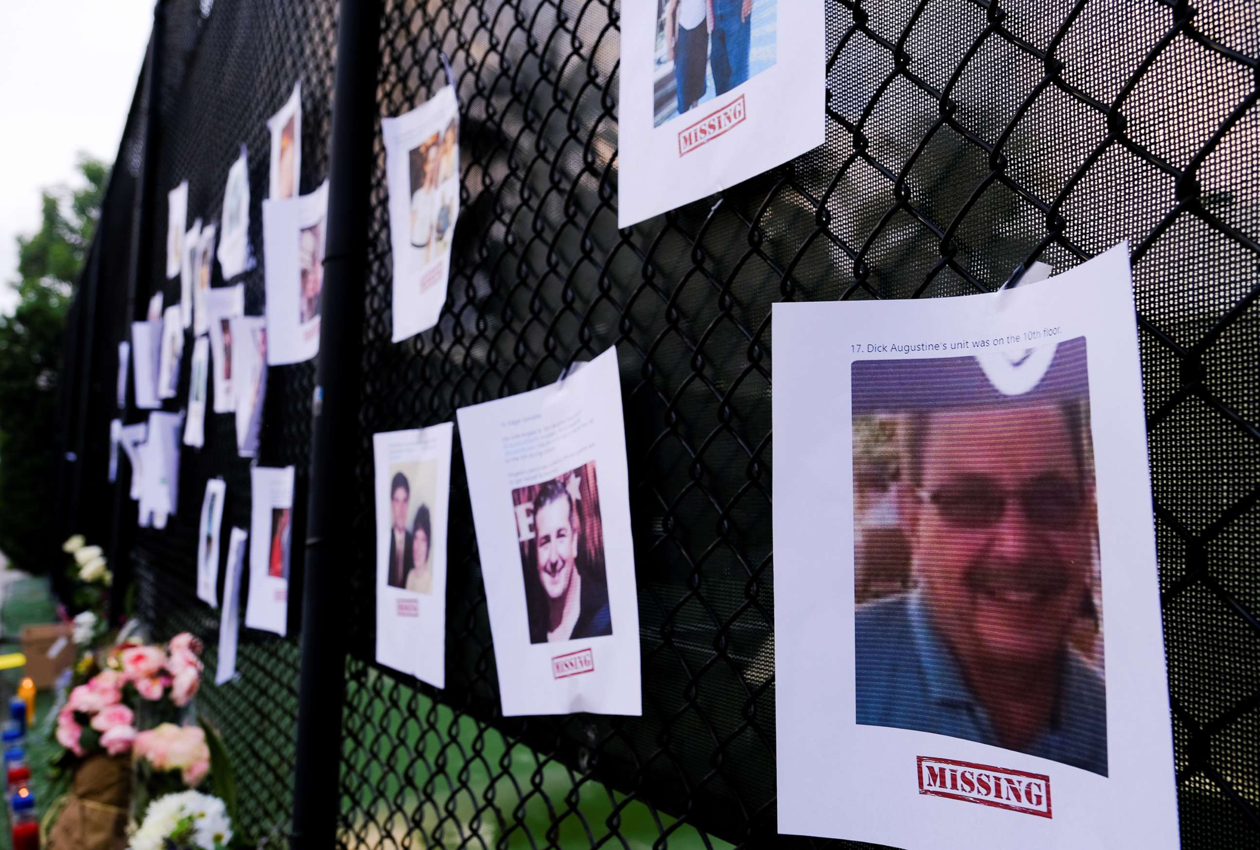 PHOTO: Pictures of missing people are seen hanging on a fence at a memorial on Harding Avenue as the rescue personnel continue their search for victims the day after a partial building collapse in Surfside near Miami Beach, Floa., June 25, 2021. 