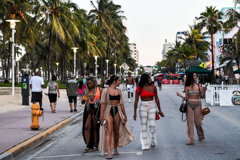 PHOTO: People walk on Ocean Drive in Miami Beach, Florida on June 24, 2020.