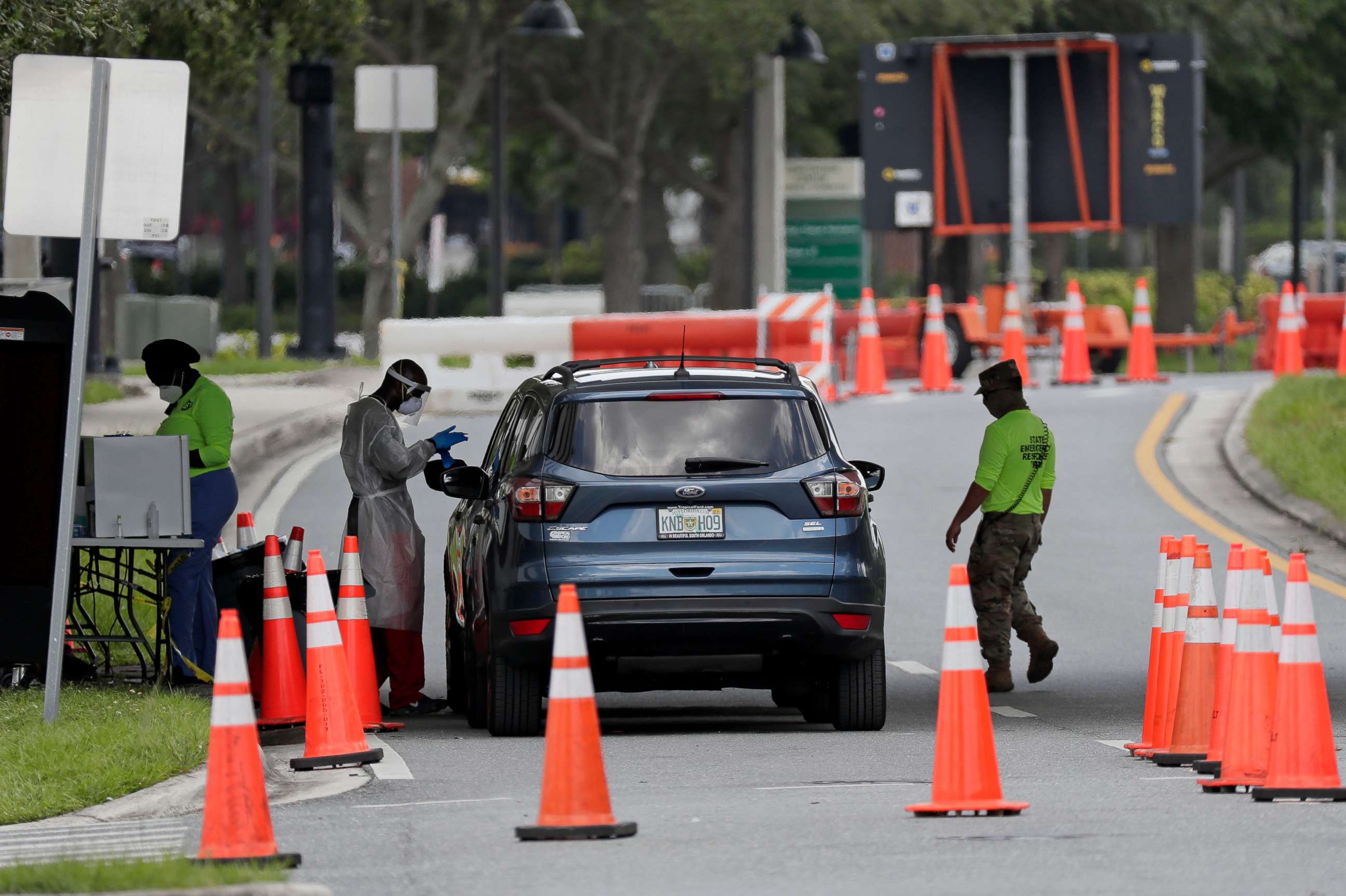 PHOTO: A health worker performs a COVID-19 test at the Orange County Convention Center,  July 12, 2020, in Orlando, Fla.