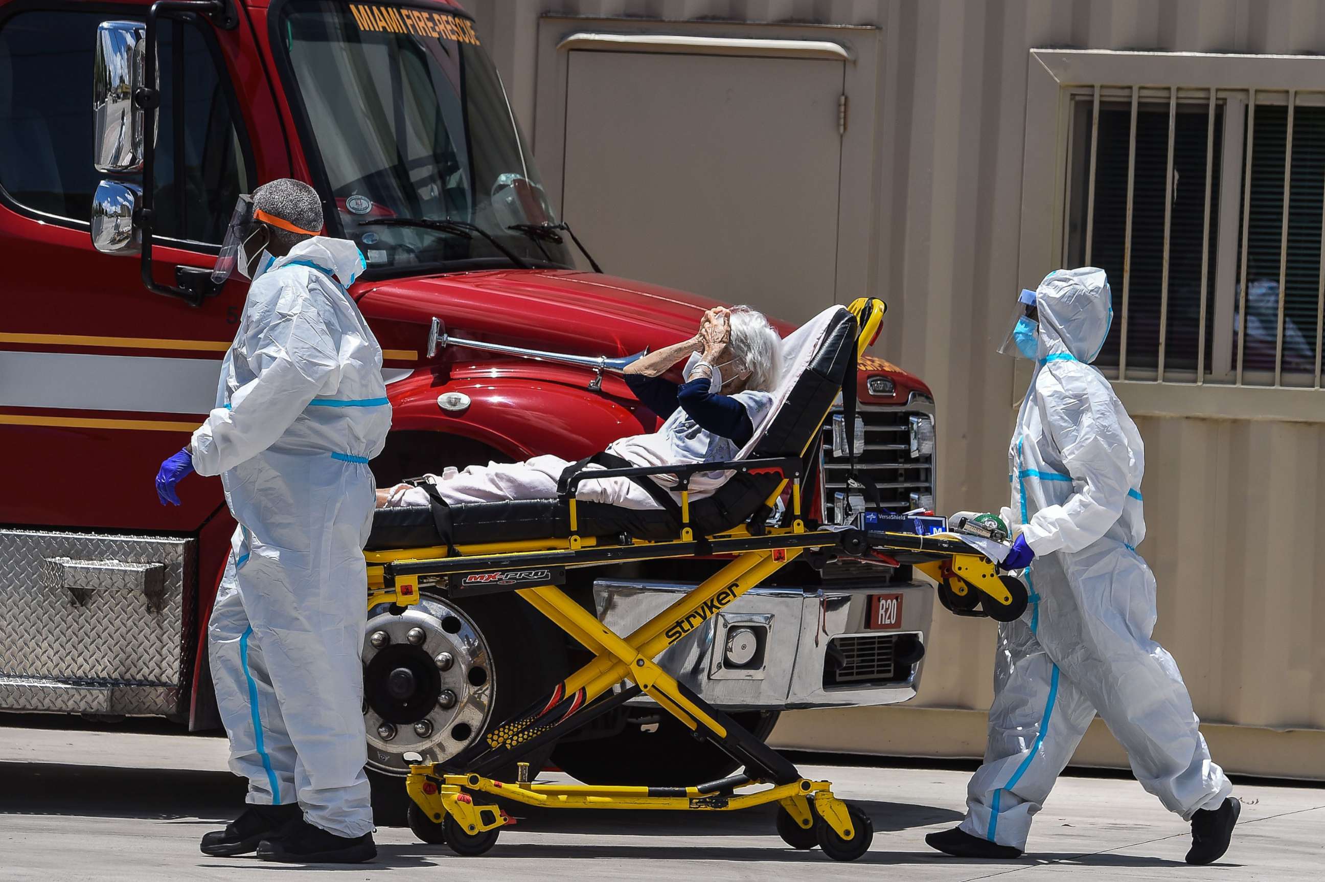 PHOTO: Medics transfer a patient on a stretcher from an ambulance outside of Emergency at Coral Gables Hospital where COVID-19 patients are treated in Coral Gables, Fla., near Miami, on July 30, 2020. 