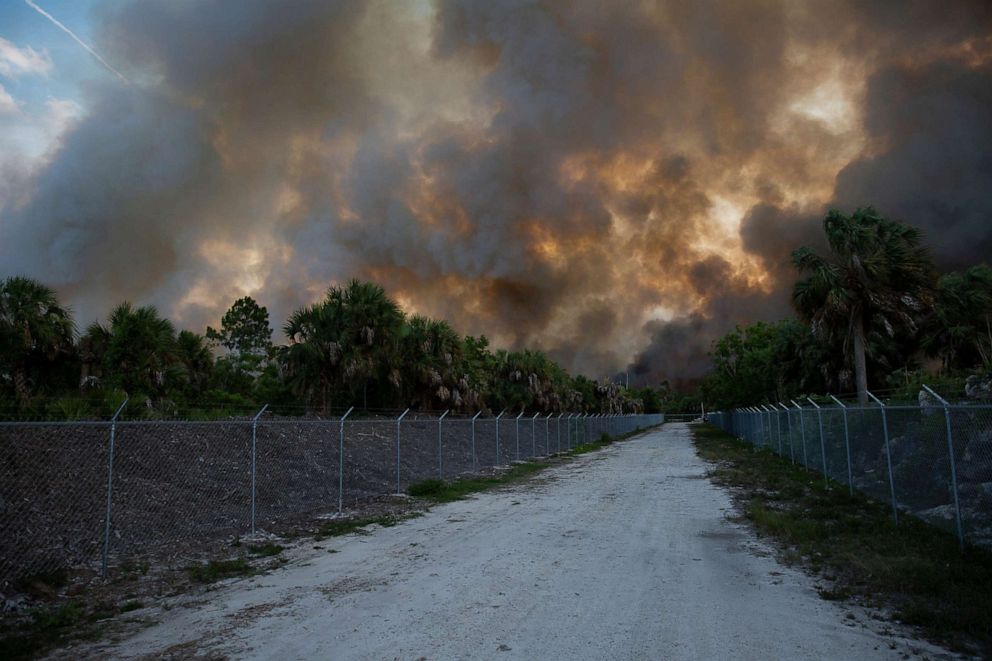 PHOTO: Smoke from a brush fire inolden Gate Estates is seen from Dove Tree Lane on May 13, 2020 in Florida.