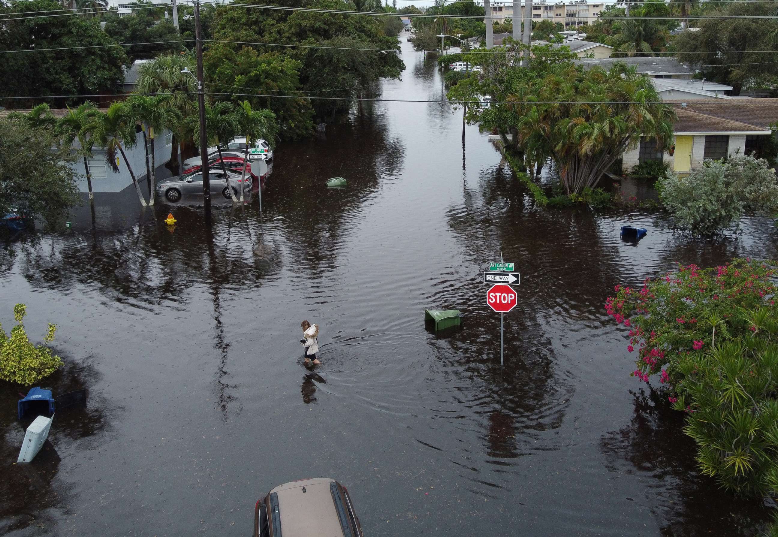 PHOTO: HALLANDALE, FLORIDA - DECEMBER 23: An aerial view from a drone shows a woman crossing a street inundated with flood water on December 23, 2019 in Hallandale, Florida. 