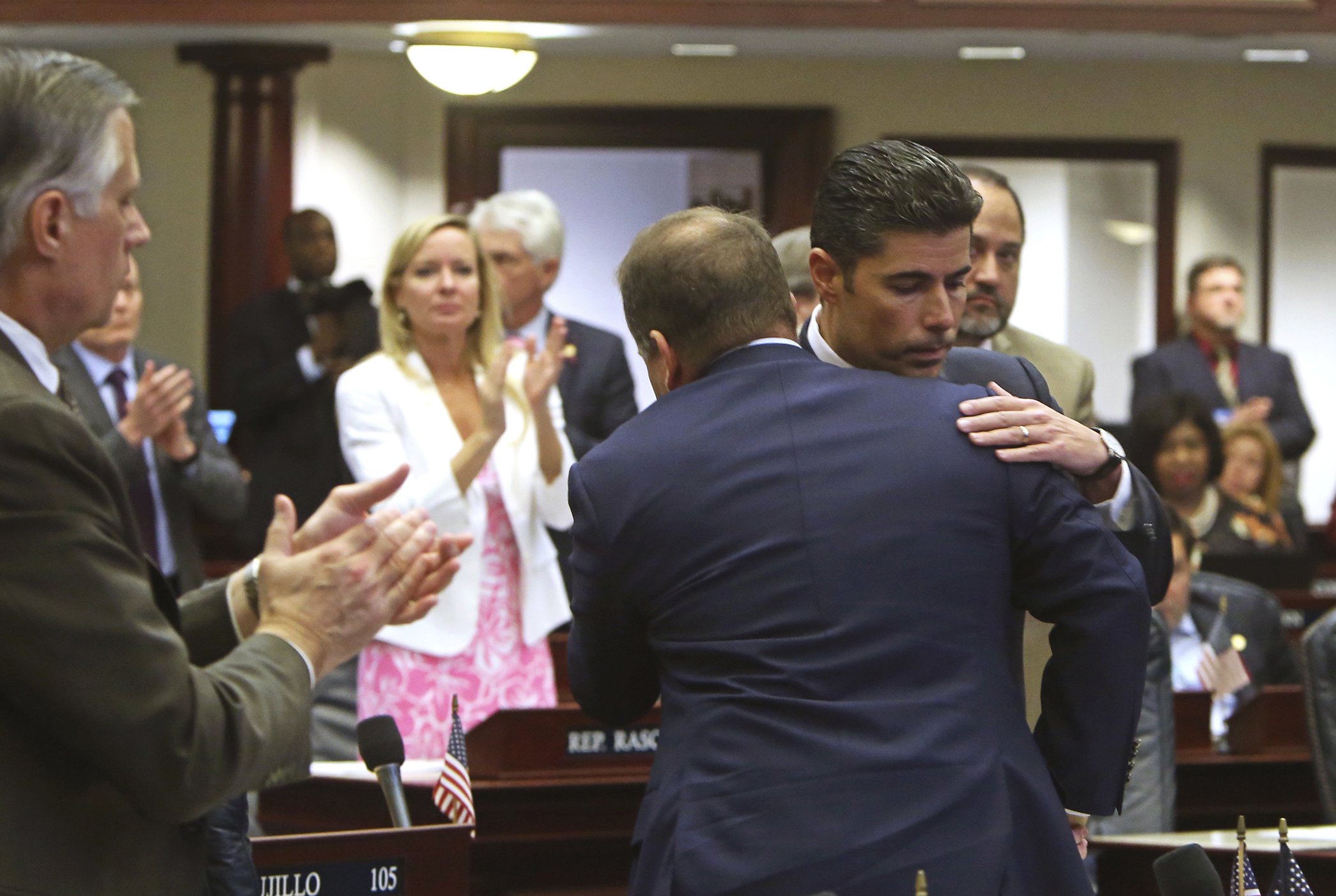 PHOTO: Rep. Jose Oliva, R- Miami Lakes, is hugged and congratulated by House members as the gun and school safety bill passed the Florida House 67-50 in Tallahassee, Fla.,March 7, 2018.