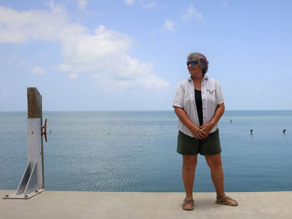 PHOTO: Cynthia Lewis, director of the Keys Marine Laboratory stands on a dock, July 25, 2023. Lewis has overseen operations as a coral evacuation is underway, moving hundreds of corals to Lewis' lab as ocean temperatures hover in the mid-90s