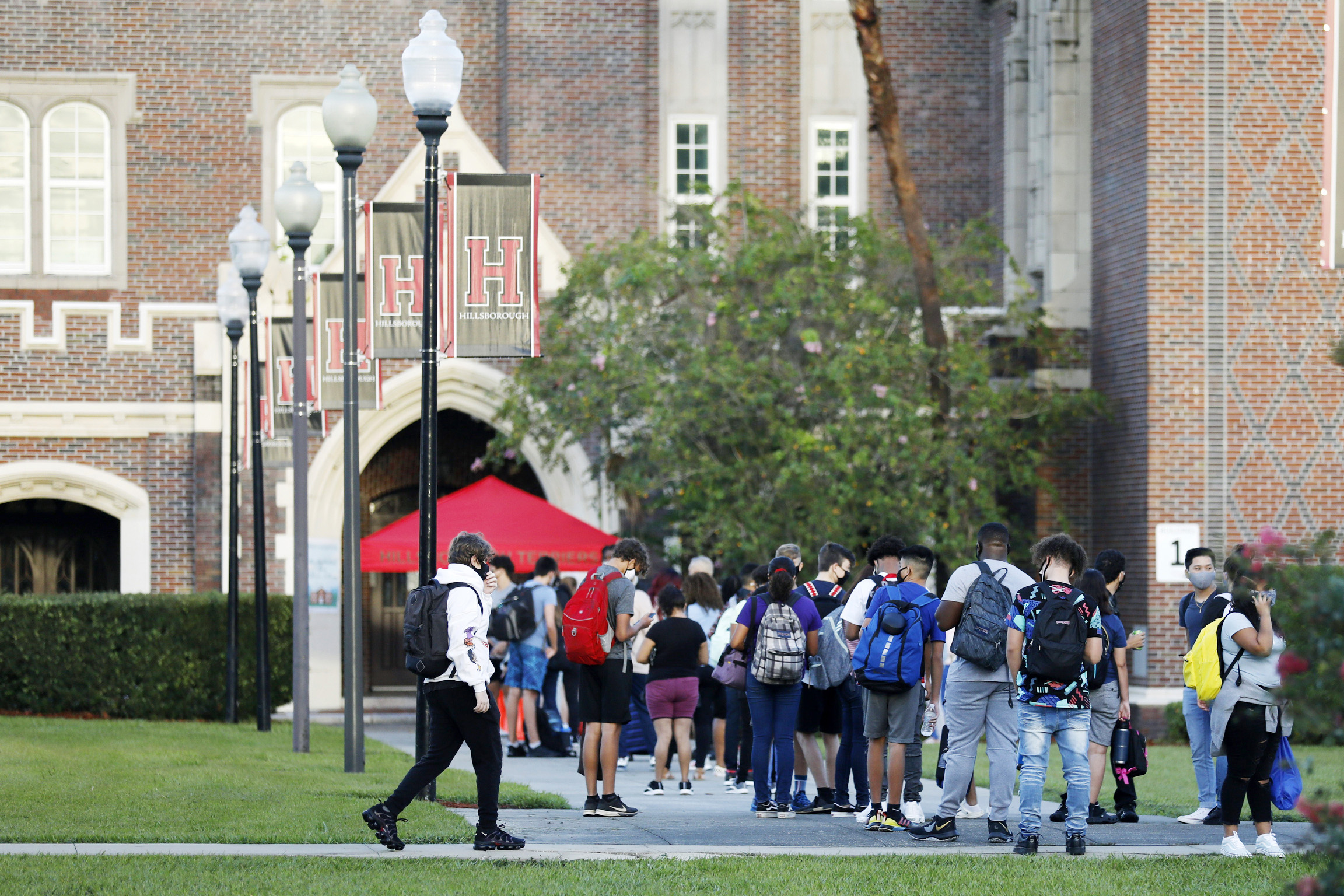 PHOTO: Students at Hillsborough High School wait in line to have temperature checked before entering the building on Aug. 31, 2020, in Tampa, Fla.