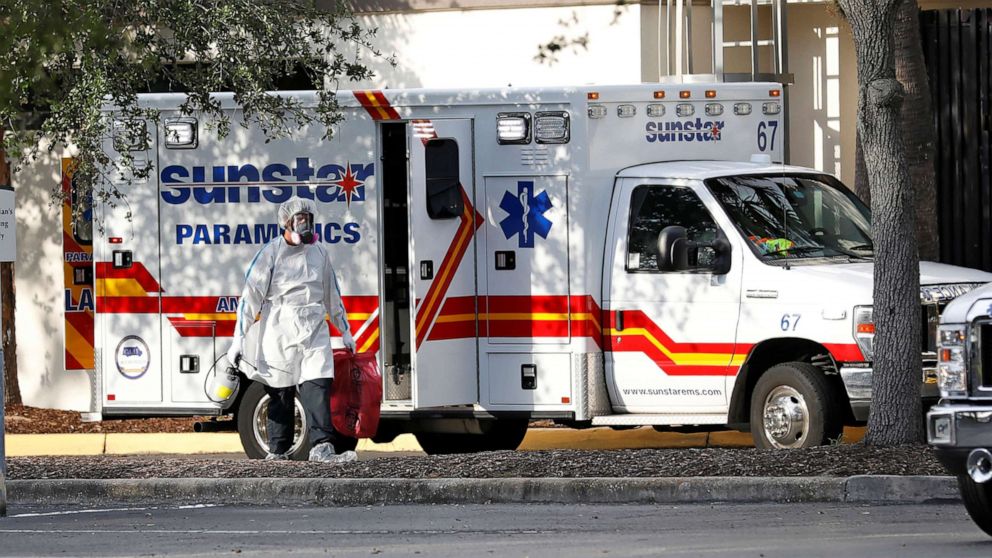 PHOTO: A paramedic dressed in personal protective equipment exits an ambulance at St. Petersburg General Hospital, where COVID-19 cases are being treated, in St. Petersburg, Fla., July 15, 2020.