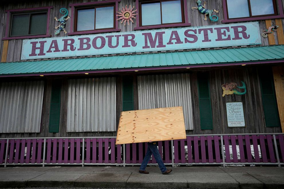 PHOTO: Adam Henderson, owner of Harbour Master Suites, prepares his business ahead of the expected arrival of Hurricane Idalia, Aug. 29, 2023, in Cedar Key, Fla.