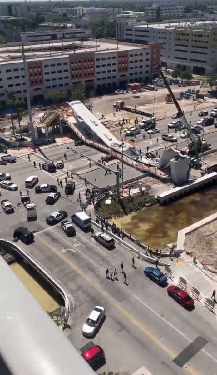 PHOTO: First responders were seen tending to injured victims on the scene of a pedestrian bridge that collapsed on the Florida International University campus. 