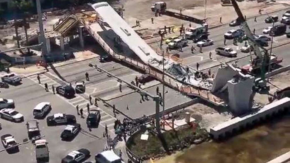 PHOTO: First responders were seen tending to injured victims on the scene of a pedestrian bridge that collapsed on the Florida International University campus. 