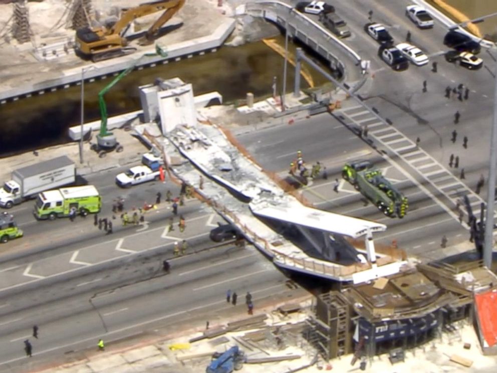 PHOTO: First responders were seen tending to injured victims on the scene of a pedestrian bridge that collapsed on the Florida International University campus. 